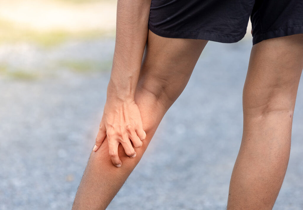 person holding calf muscle